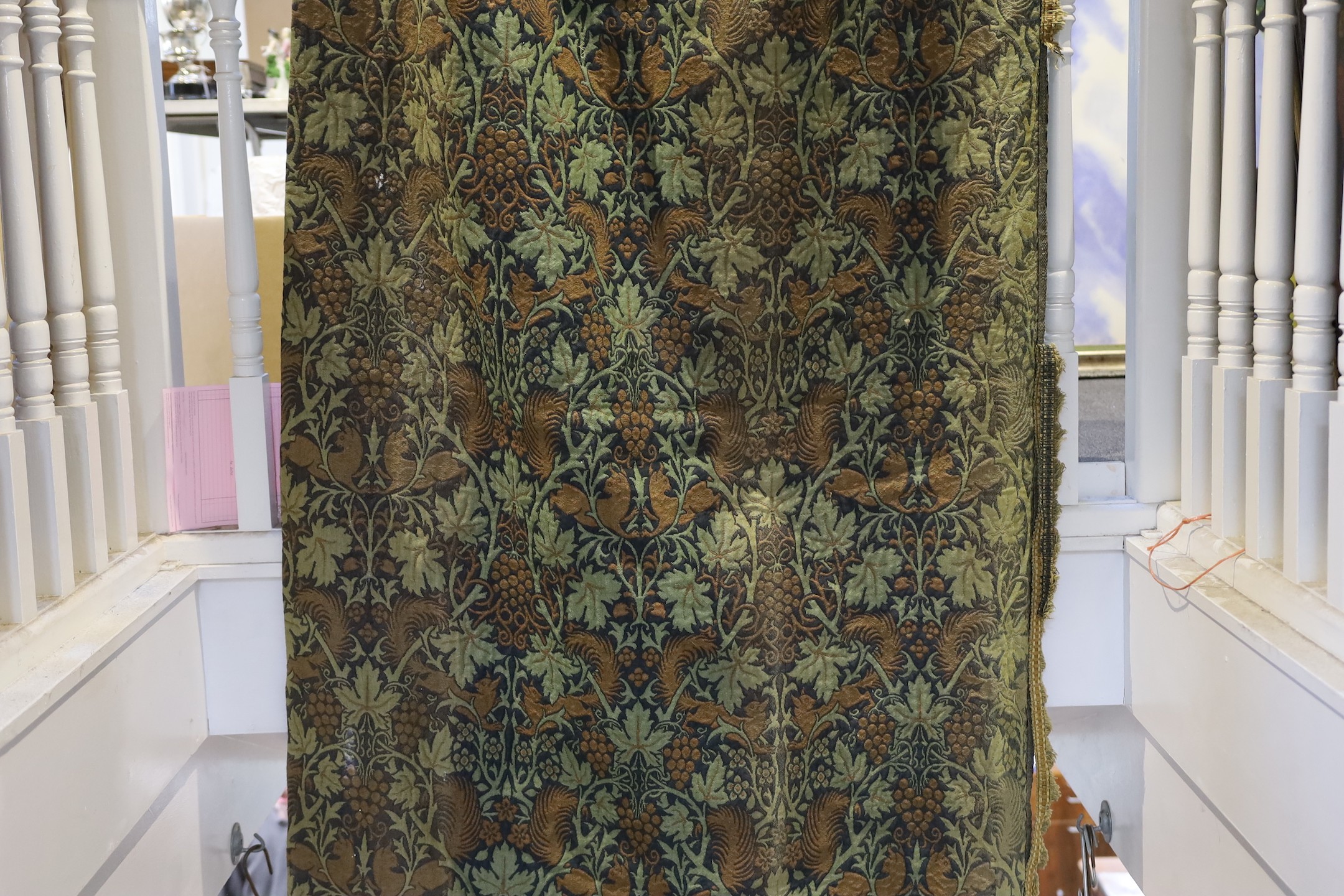 John Henry Dearle for Morris & Co. a pair of Squirrel design curtains, c.1890, hand loom woven wool at Merton Abbey, each with ornate braided edging and lining: 8ft 6ins. drop x 4ft wide each